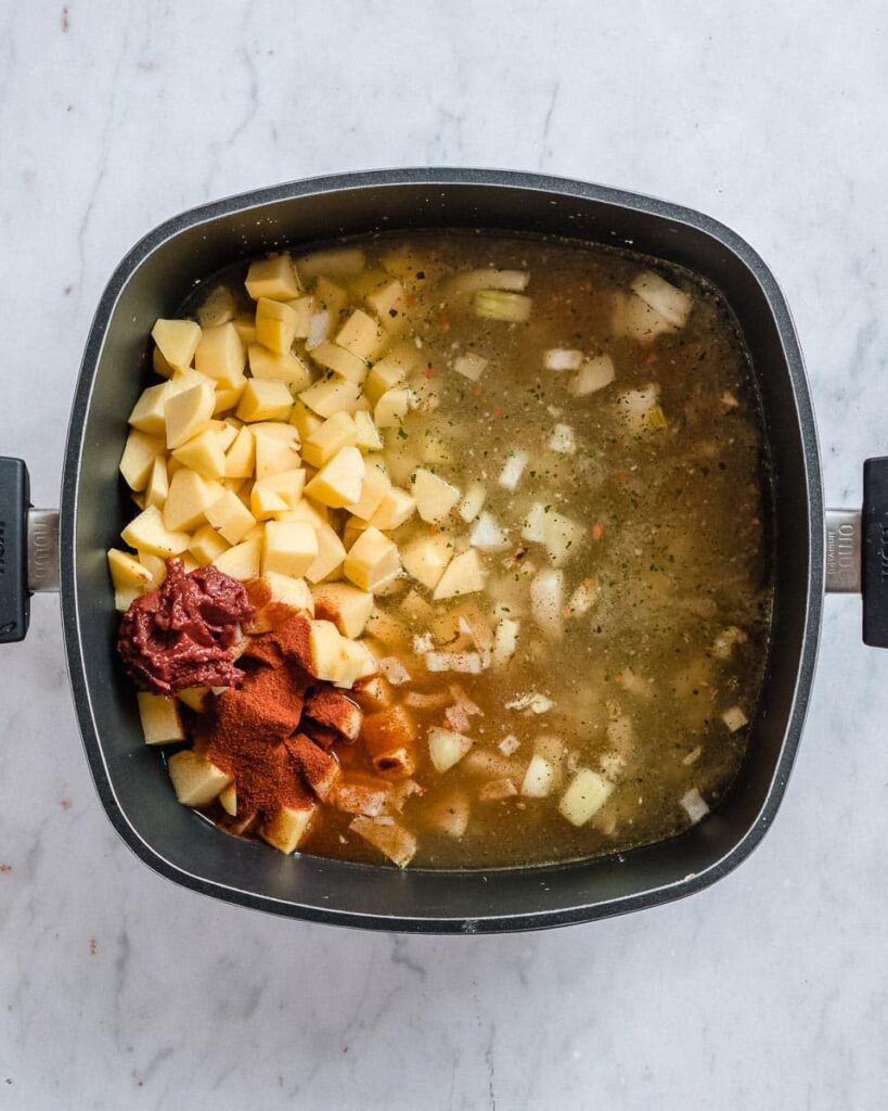 potatoes, veggies tock, tomato paste and paprika powder in a big soup pot
