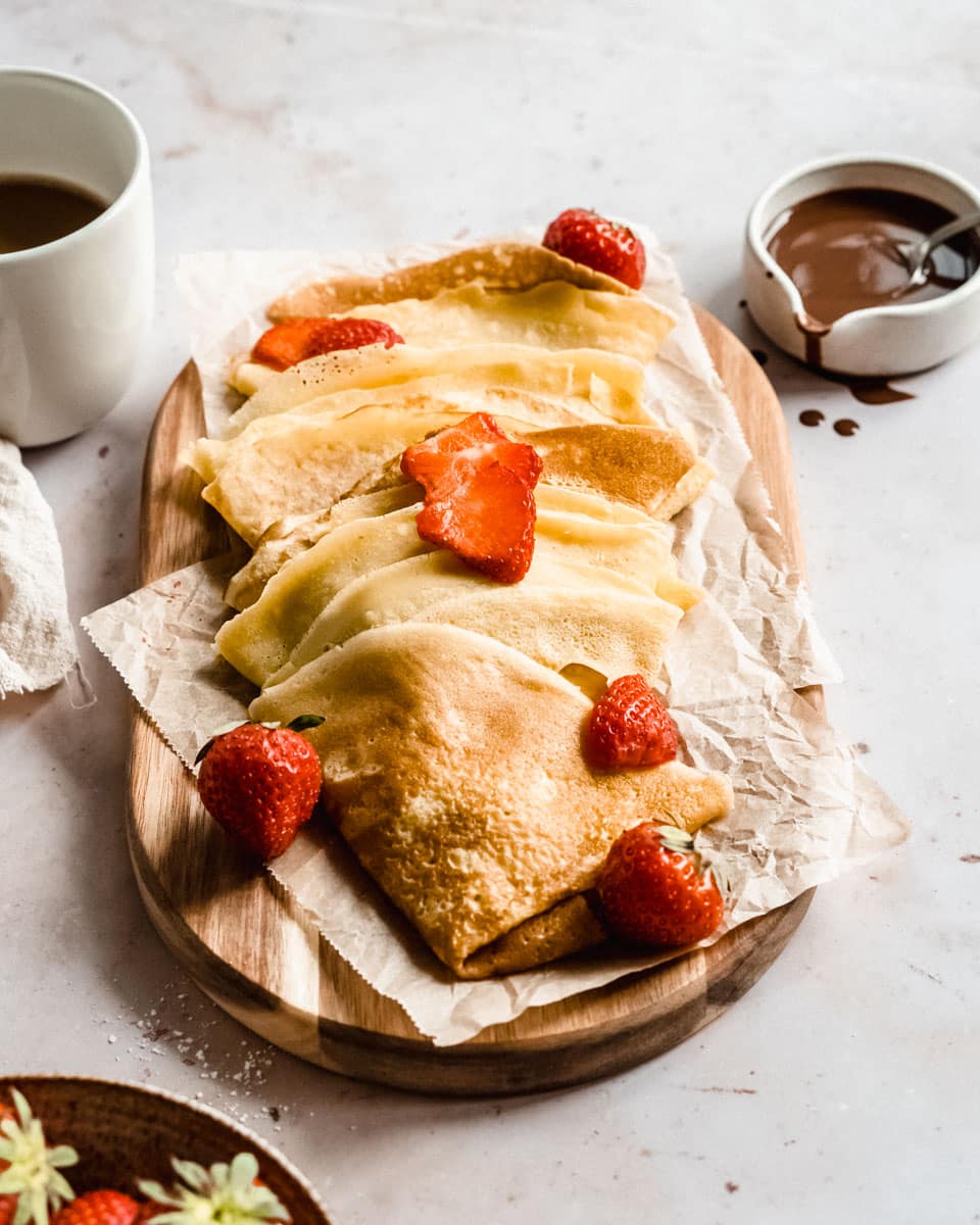 almond milk crepes on a wooden board.
