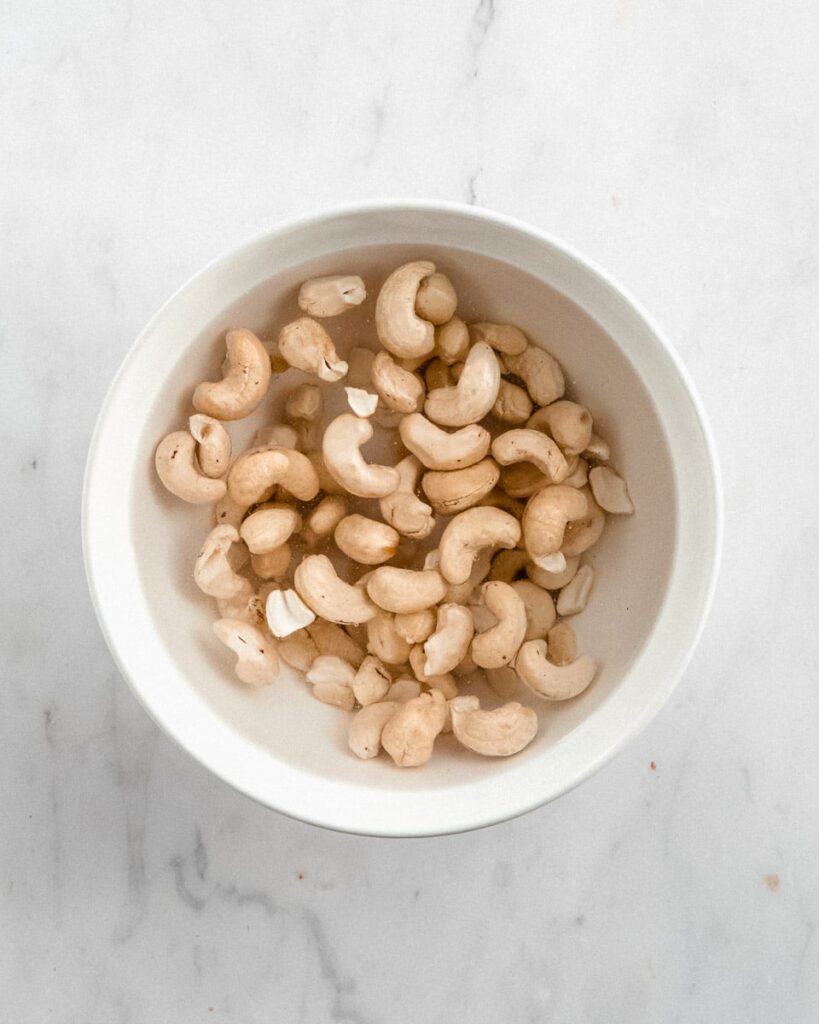 cashews soaked in a bowl of hot water