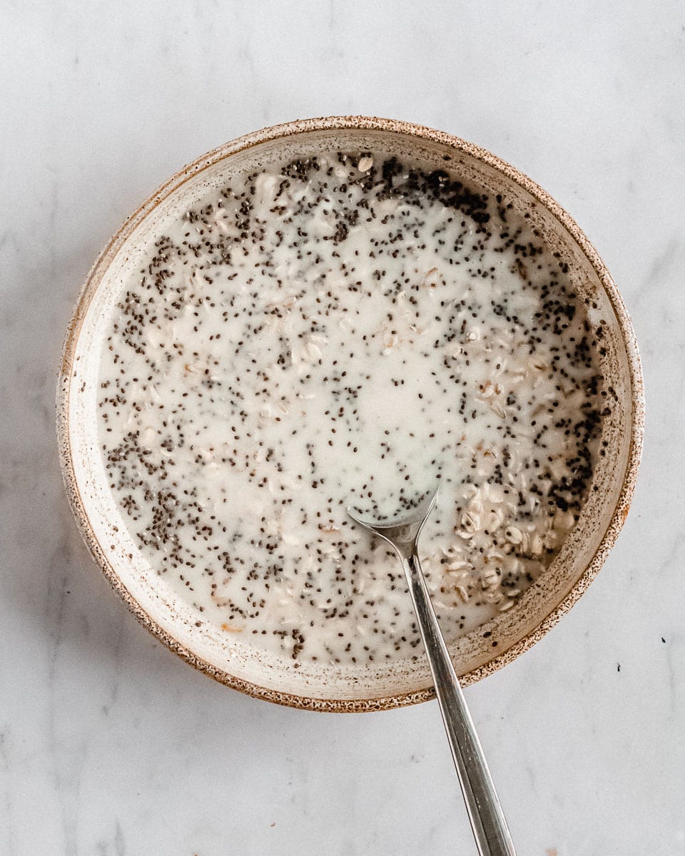 oats, water, maple syrup, pinch of salt, chia seeds and yogurt thoroughly mixed together in a ceral bowl