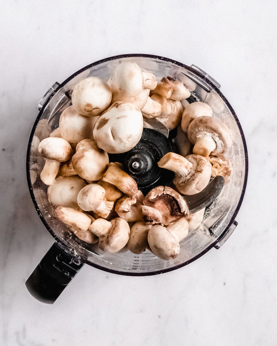 white button mushrooms in a food processor