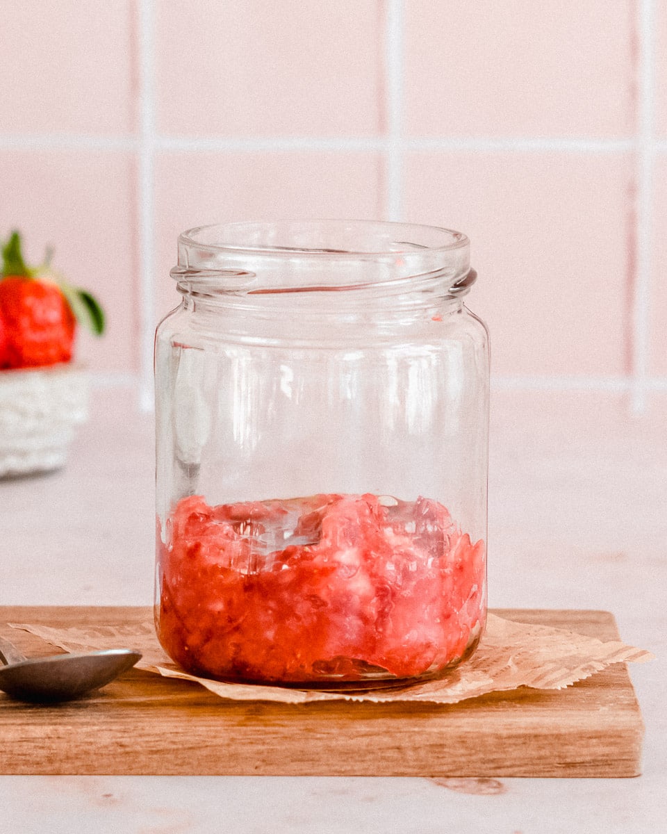 glas jar ⅓ added with muddled strawberries