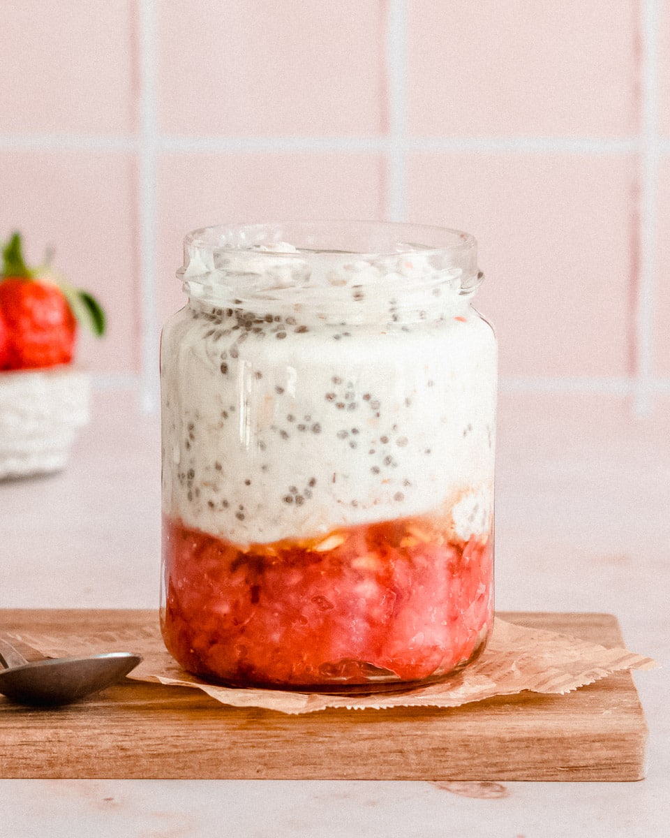 glas jar filled ⅓ added with muddled strawberries, and ⅔ overnight oats with water