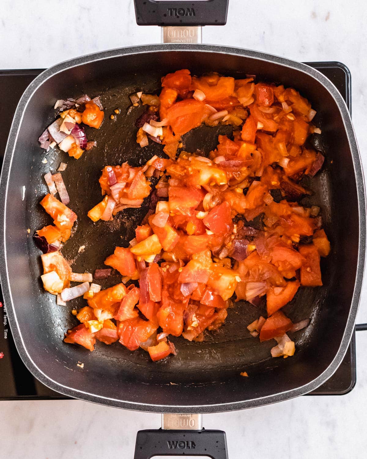 cooked onion and garlic and cooked, soft tomatoes in a large pot.