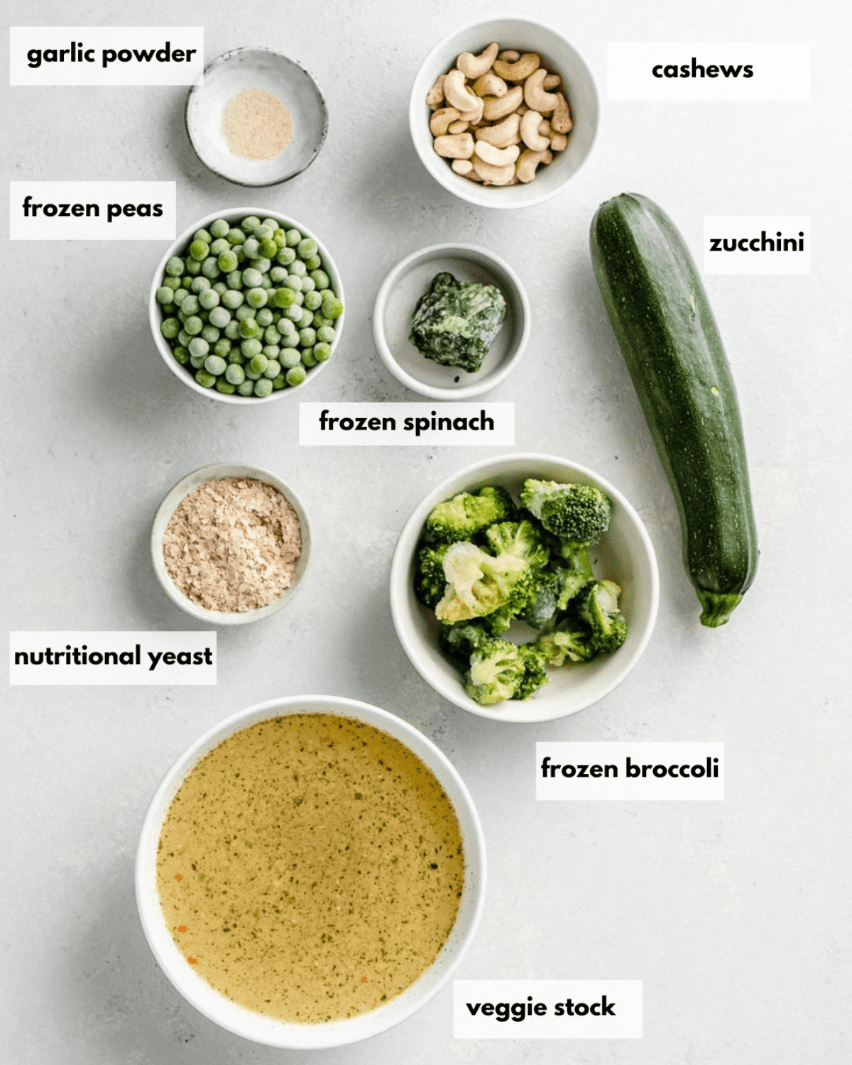 all ingredients needed to make broccoli and pea soup lying on a table.