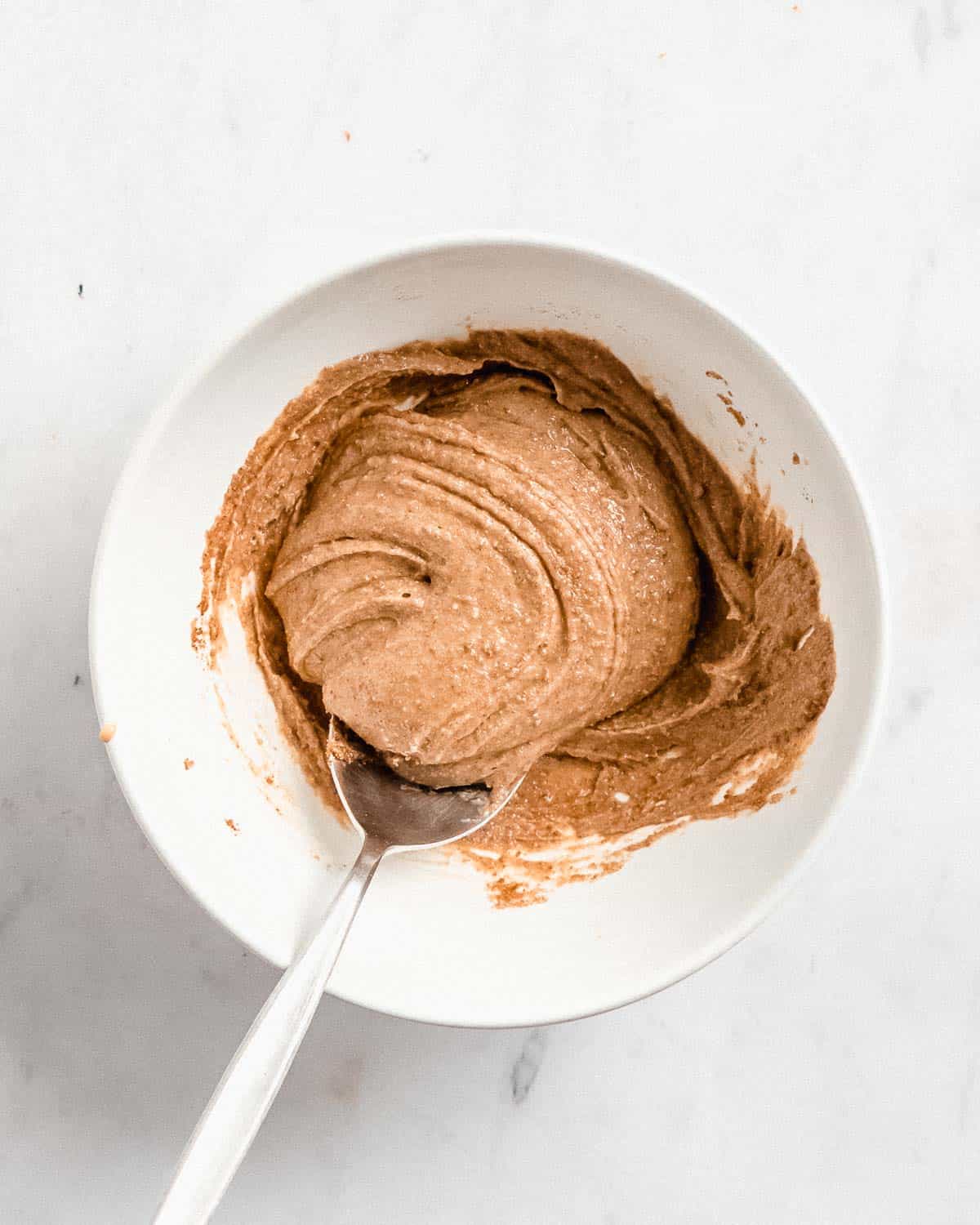 peanut butter and coconut sugar whisked together in a bowl.