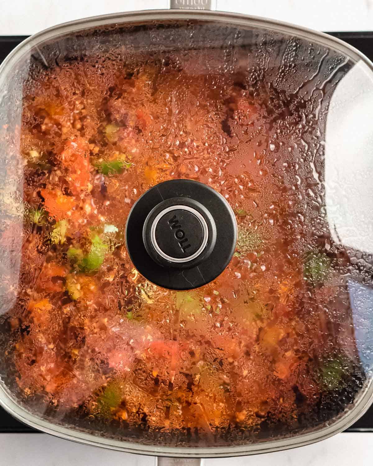 frying pan with a lid on, it in tvp meat veggie mixture.
