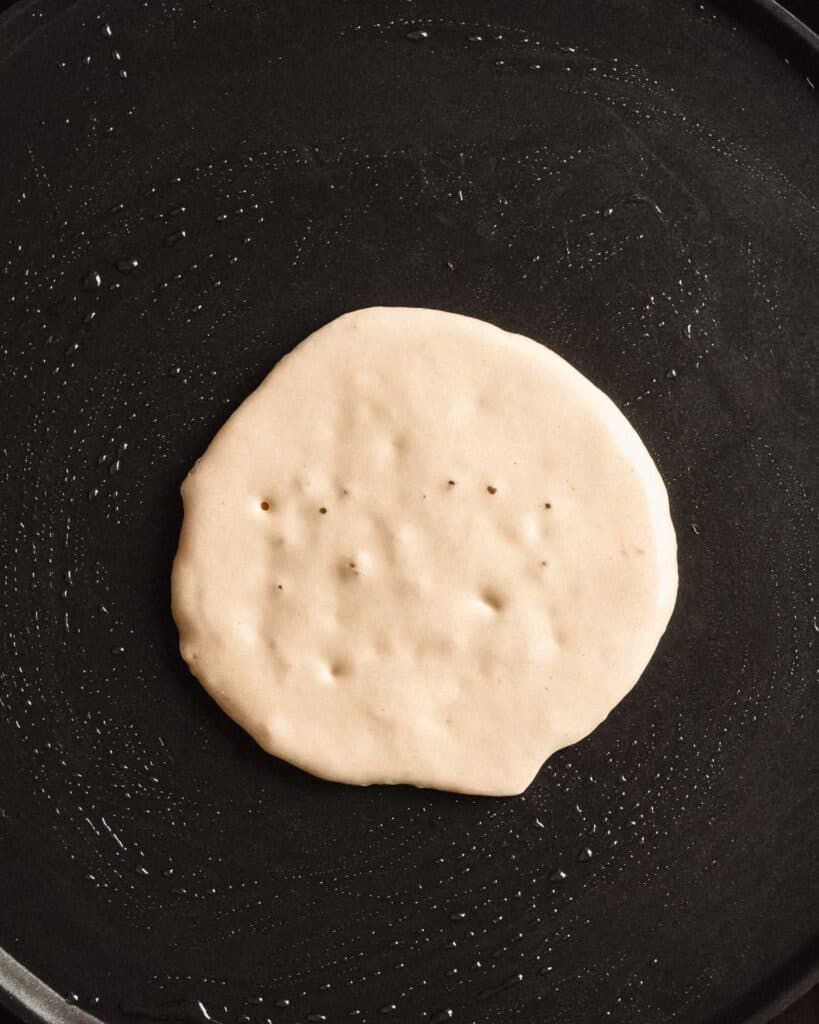 pancake batter in a pan coated with olive oil.