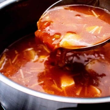 tomato enoki mushroom and tofu-soup in a big soup pot.