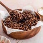 bowl of roasted lentils with a spoon spooning out one portion.