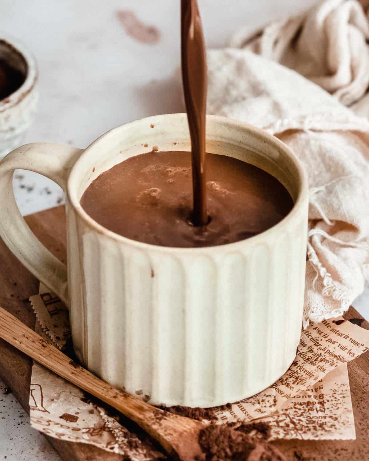 hot chocolate bein poured into a mug.