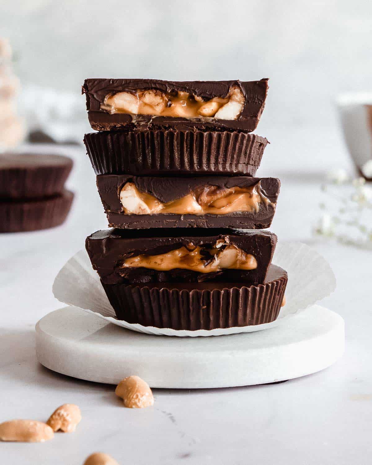 stack of 5 peanut butter cups on a littel marble plate.