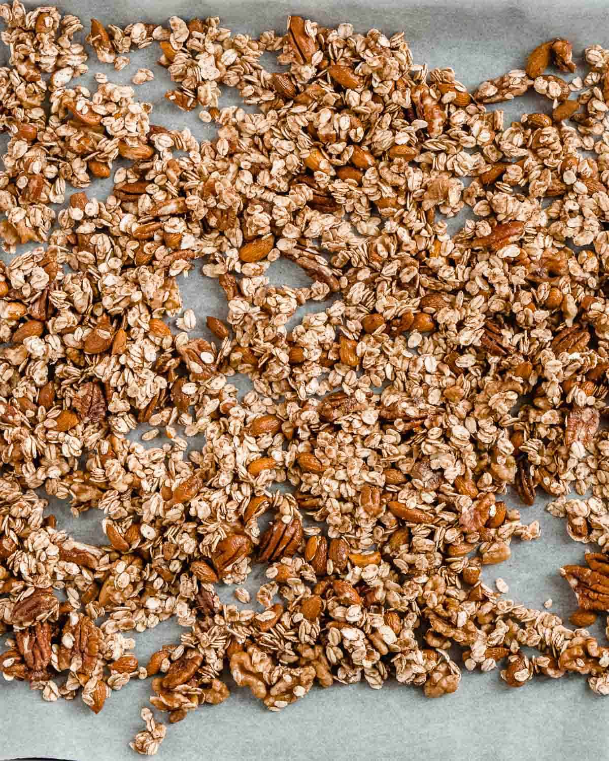 granola spread out on baking tray.