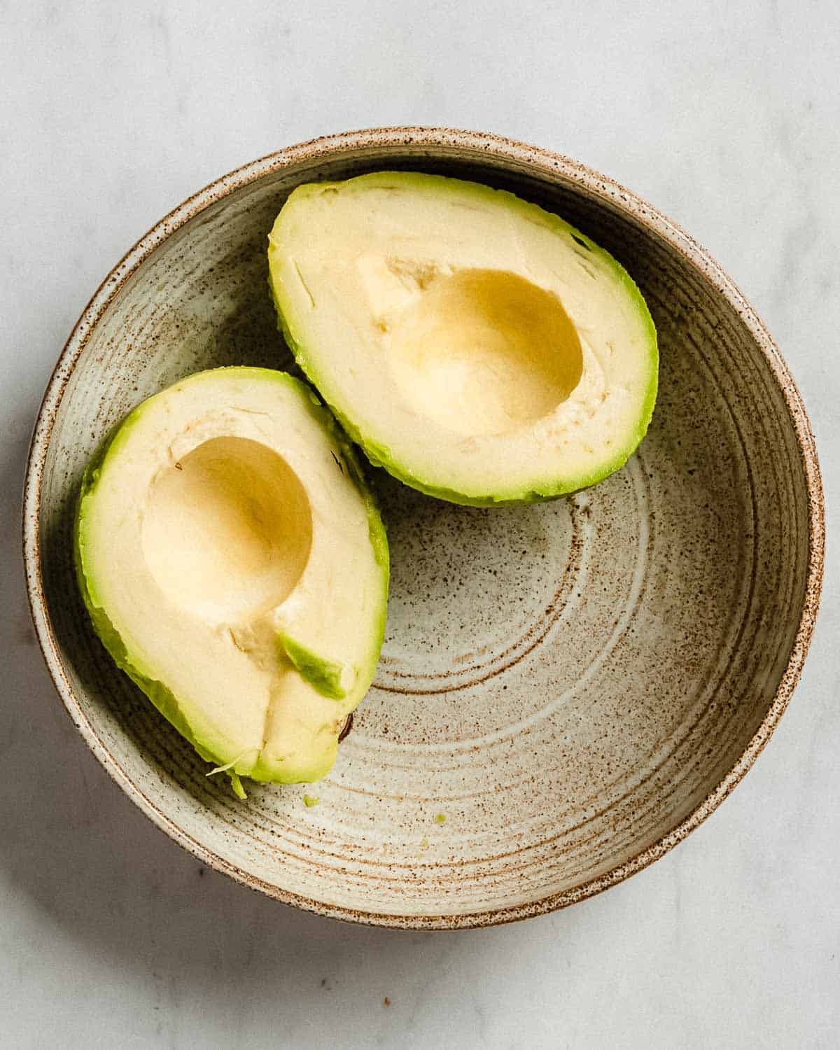 peeled avocado in a bowl.