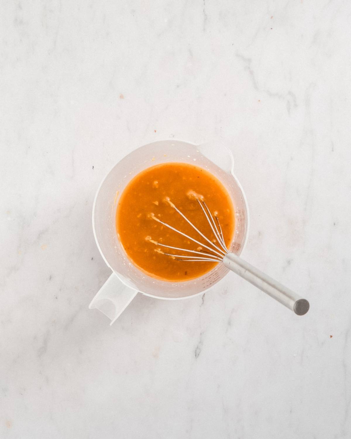 pumpkin puree, maple syrup, coconut oil, plant milk mixed together in a small bowl.
