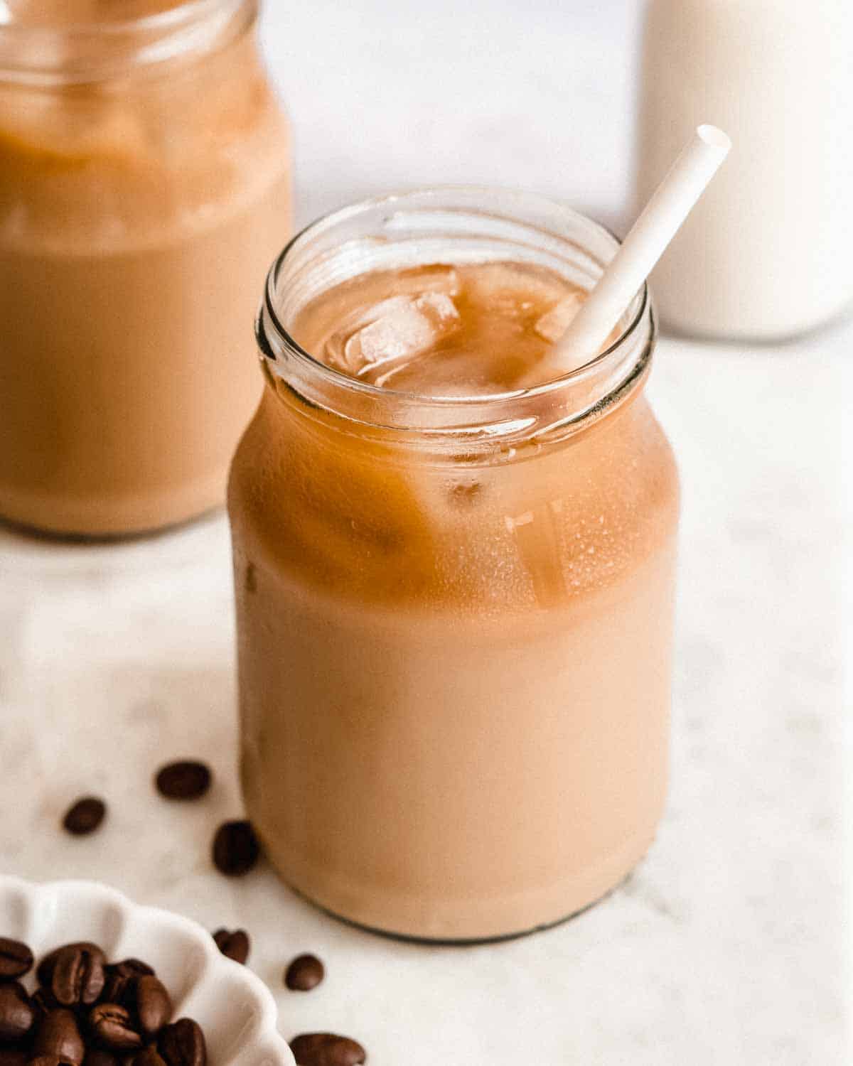 french press cold brew coffe concentrate diluted with milk in a serving glass.