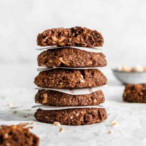 stack of 5 healthy chocolate cookies with a small paper sheet added between each cookie.
