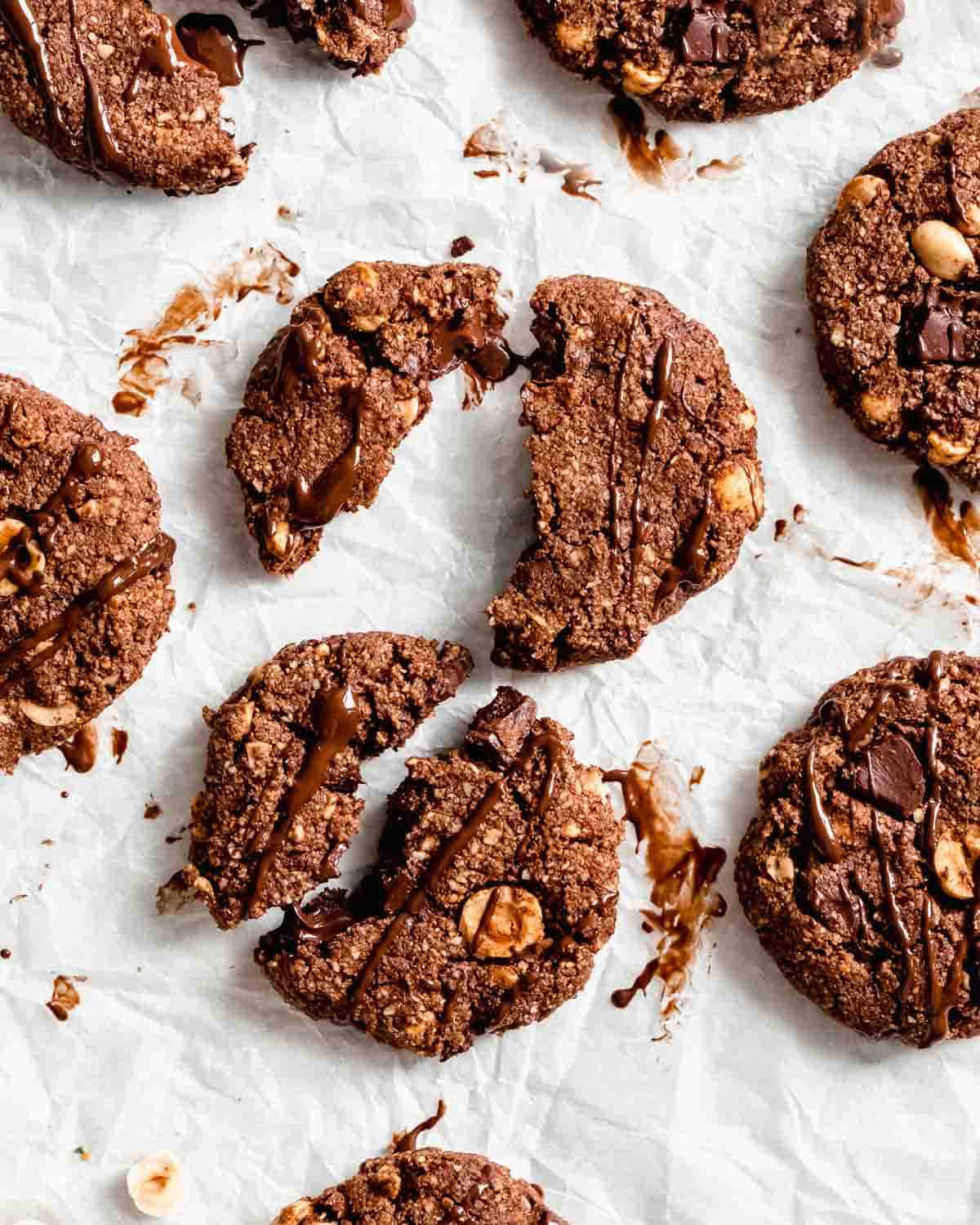 8 chocolate cookies on a cookie sheet lined with parchment paper.
