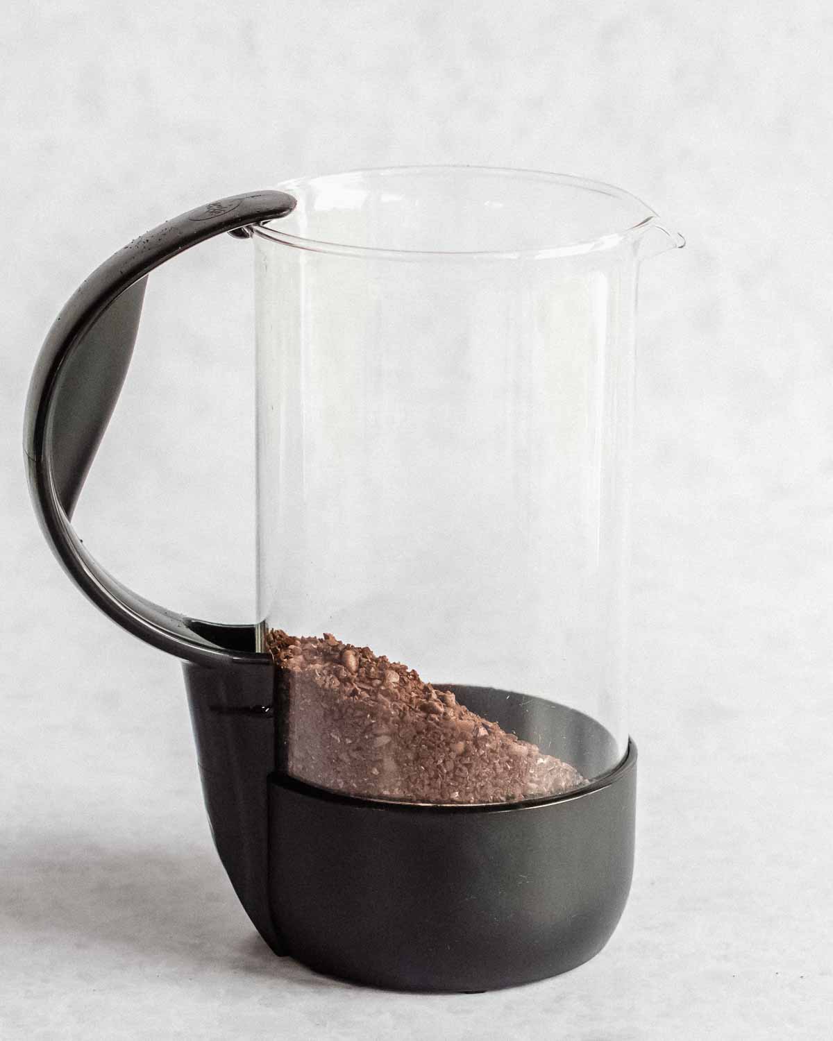 ground coffee added to the bottom of a french press.