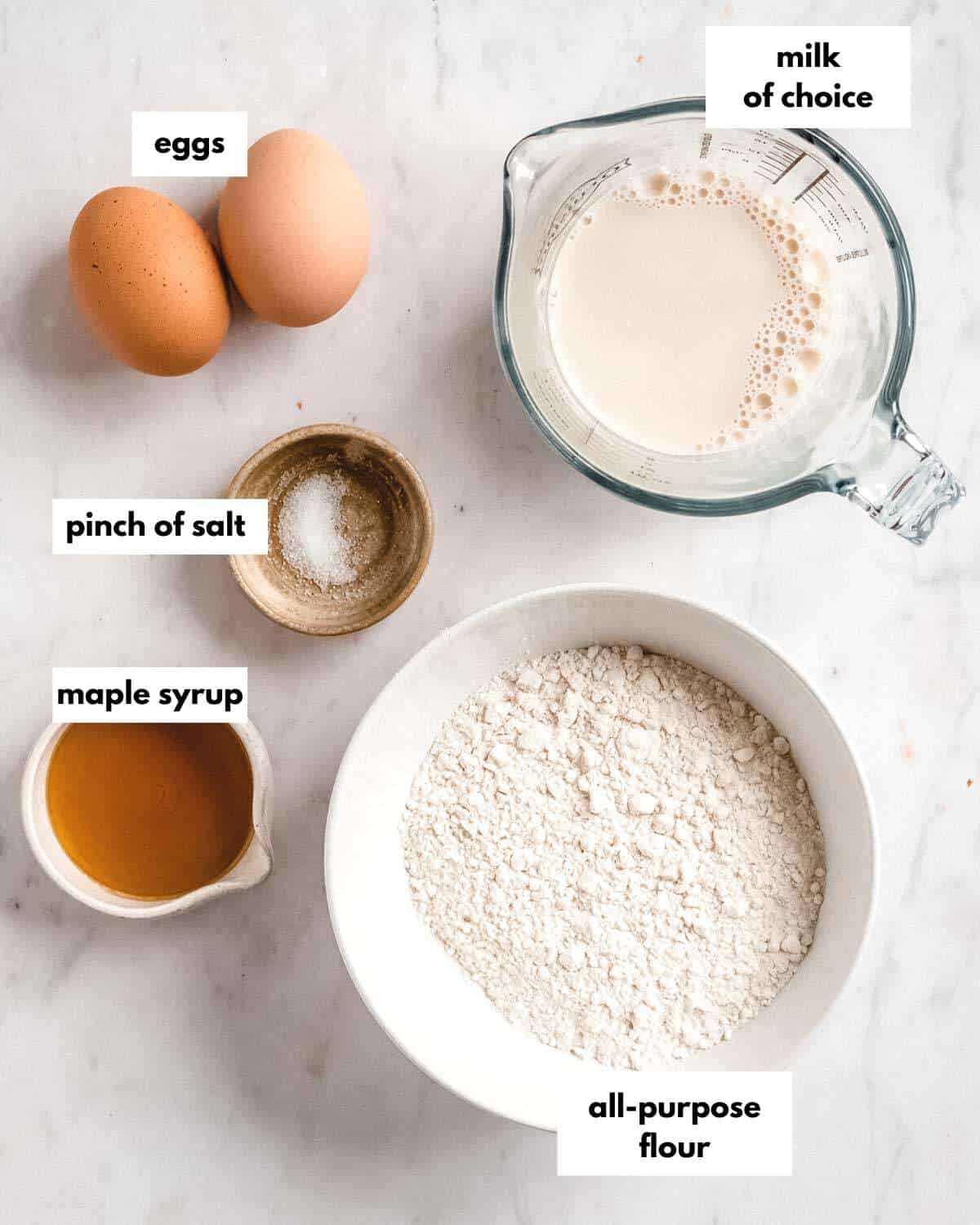 all ingredients needed to make pancakes without baking powder laid out on a table.