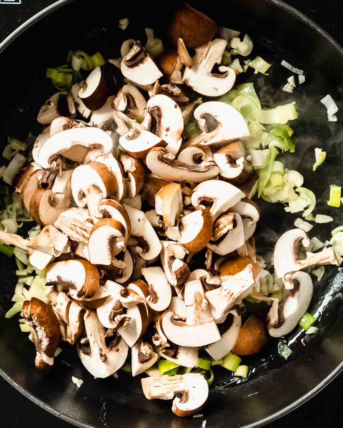 chopped mushrooms addd to the onion garlic mix in the pan.