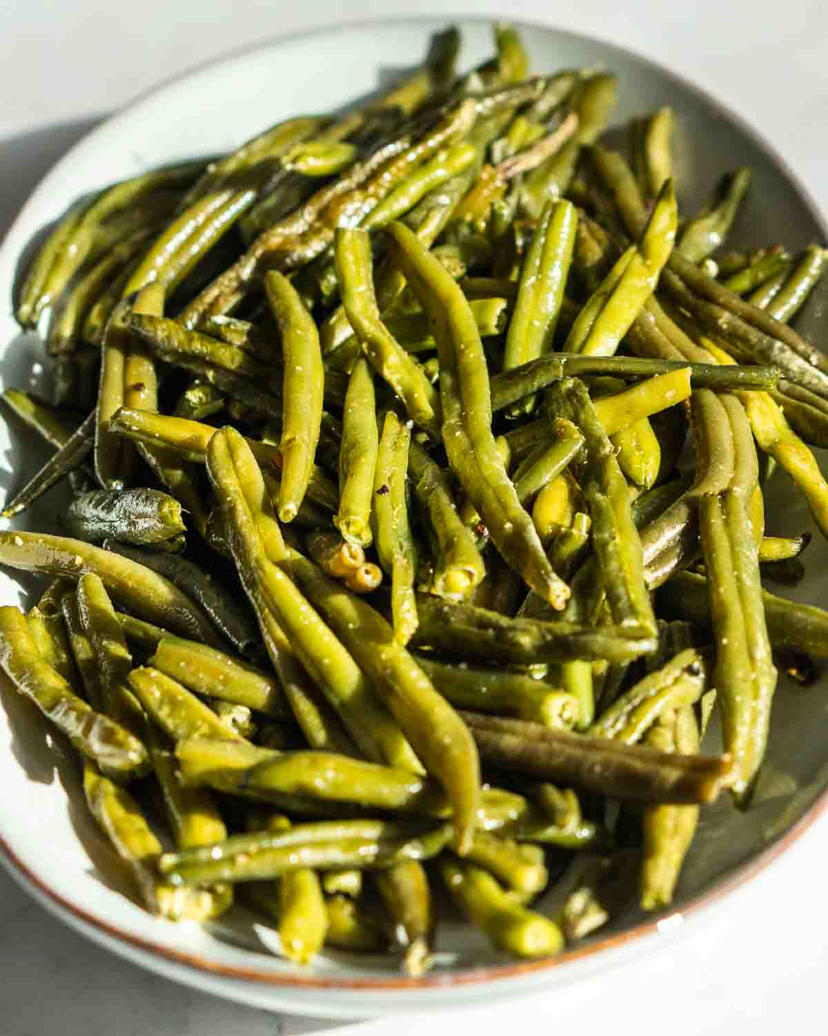 roasted green beans on a plate.