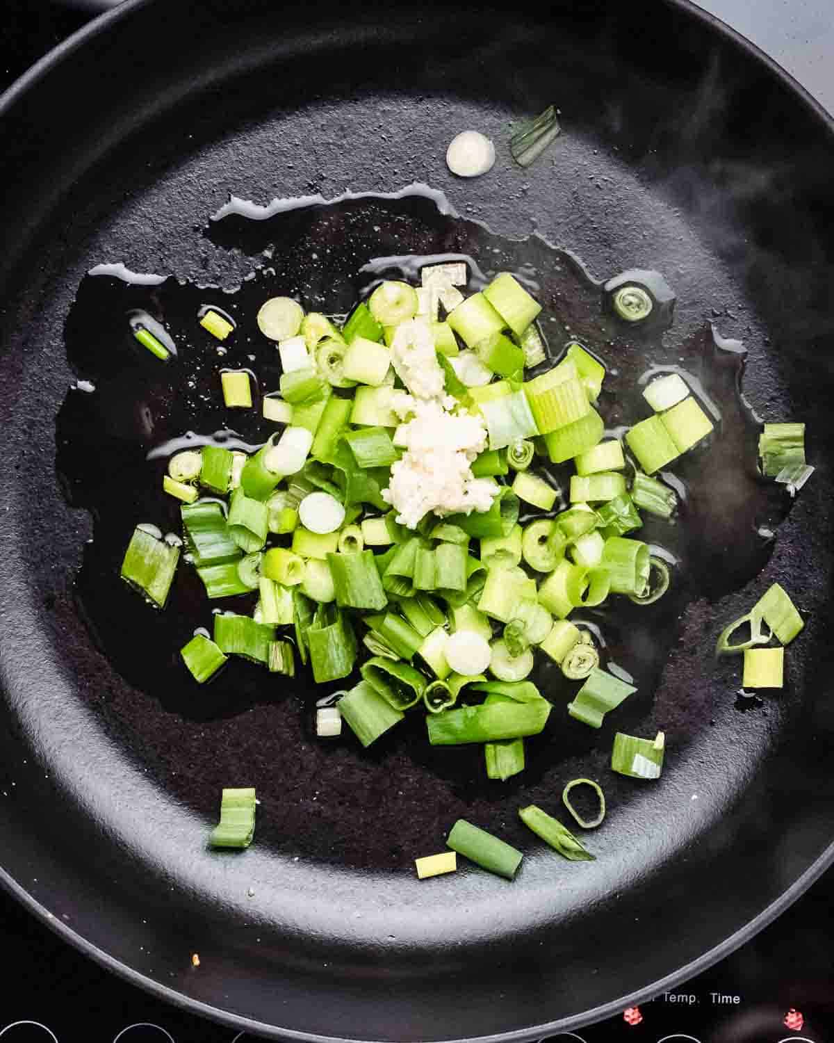 green onion and garlic in a pan.
