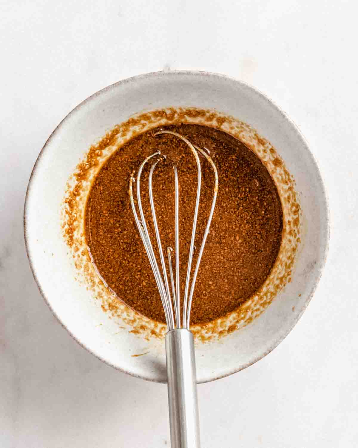 peanut butter sauce in a small bowl with a whisk.