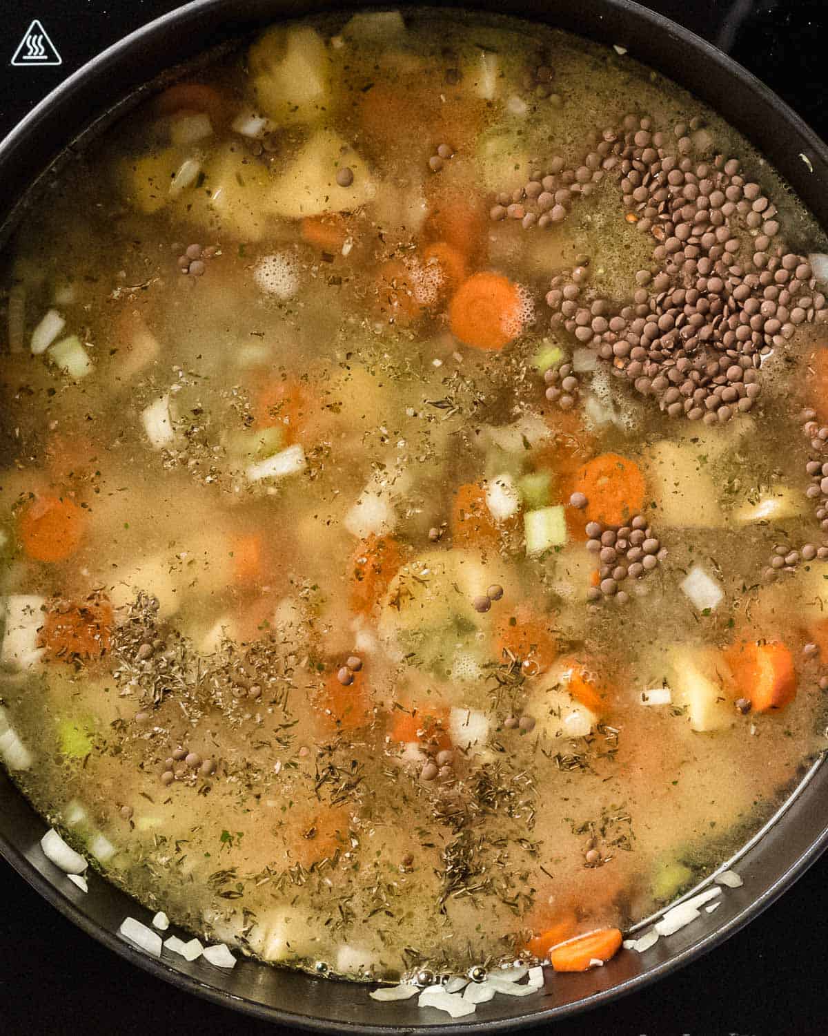 vegetarian lentil soup simmering in a pot.