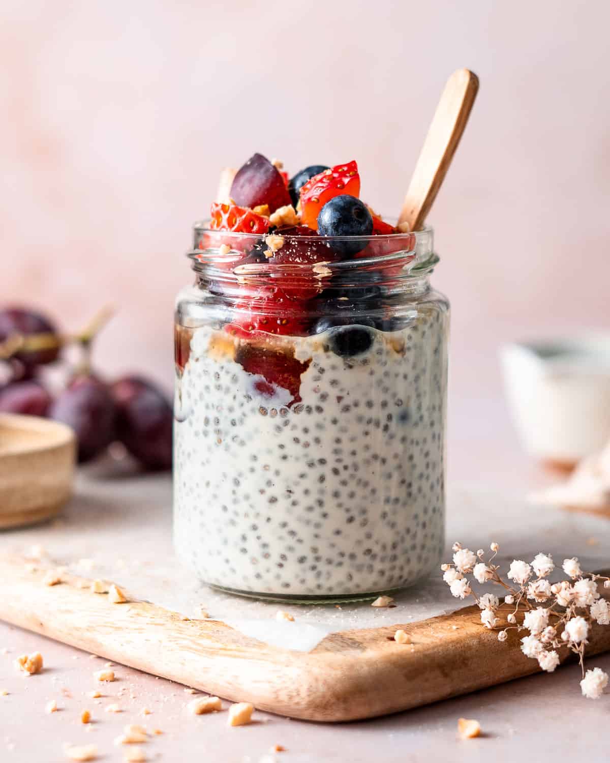 yogurt chia pudding in a glass jar and a spoon in it.