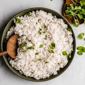 plate of coconut basmati rice topped with fresh cilantro.