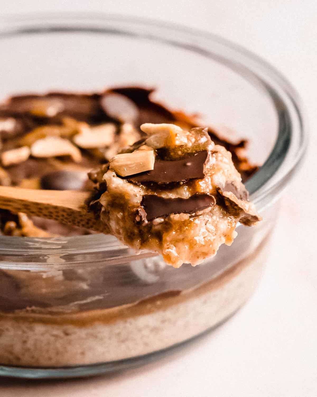 spoonful of overnight weetabix topped with caramel sauce and chocolate.