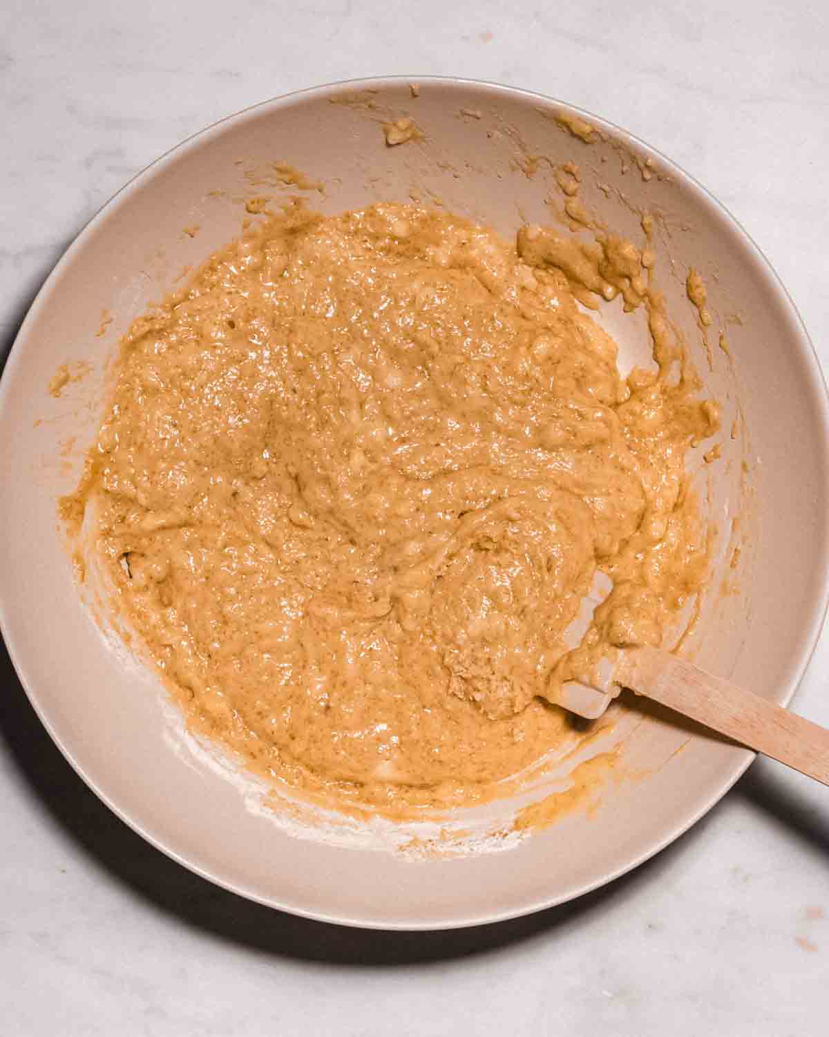 banana muffin batter in a mixing bowl.