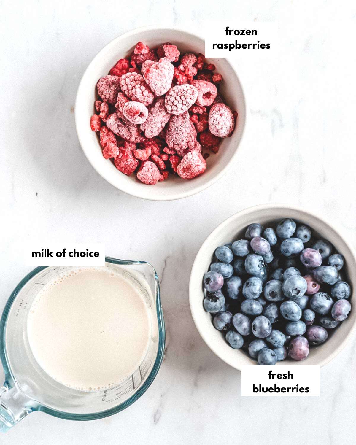 all ingredients needed to make a raspberry blueberry smoothie.