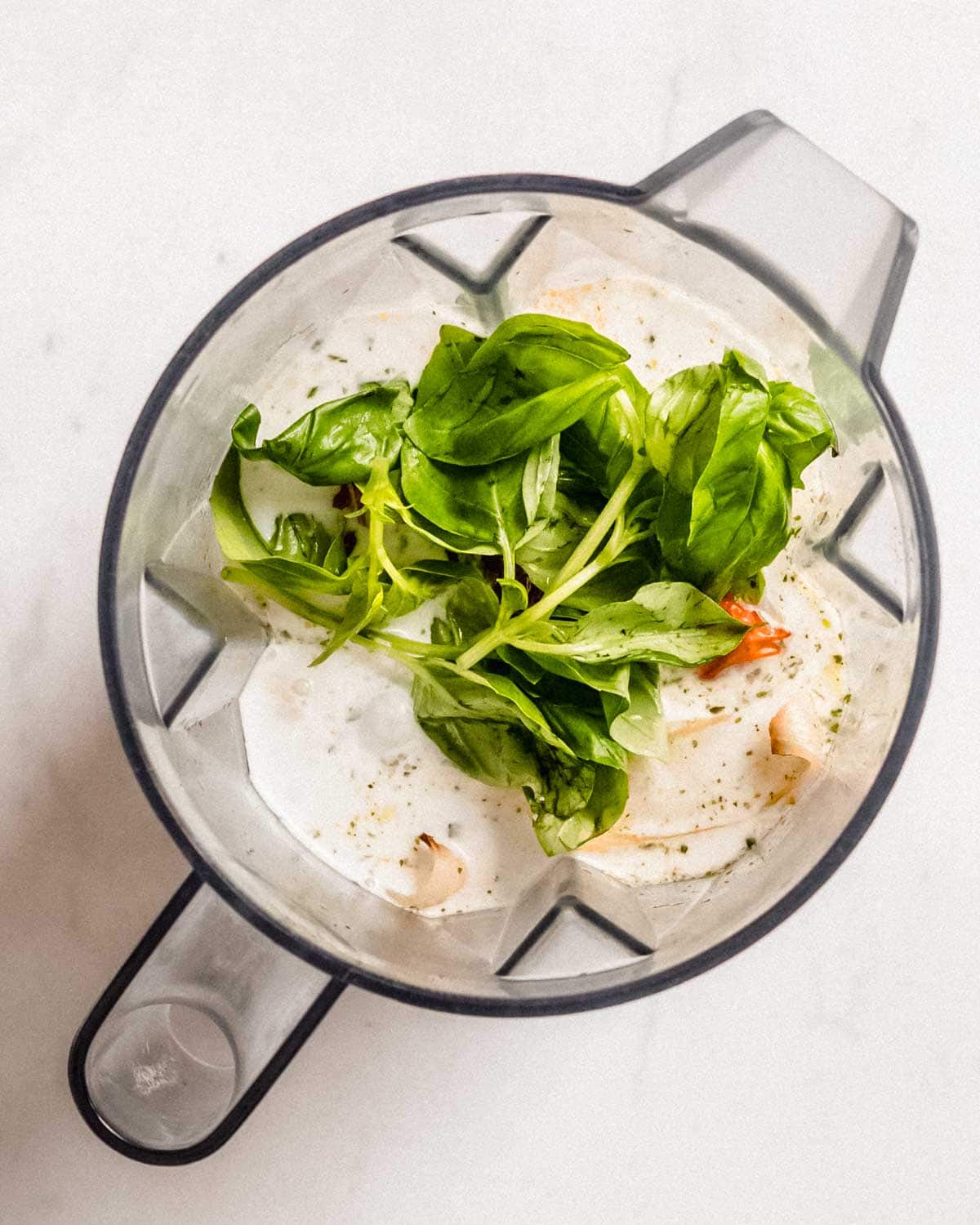all ingredients for cherry tomato soup in a blender jug.