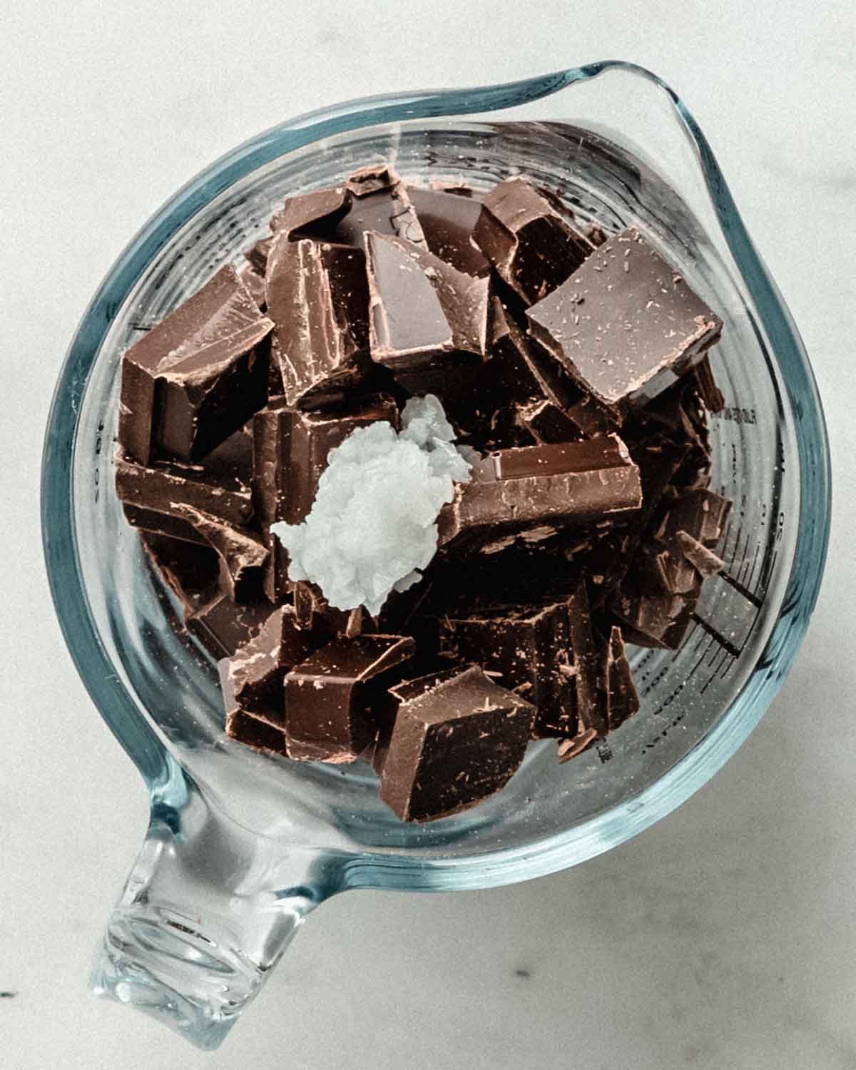 Chocolate and coconut oil in a glass jug.