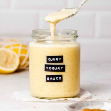 Curry yogurt sauce in a glass jar.