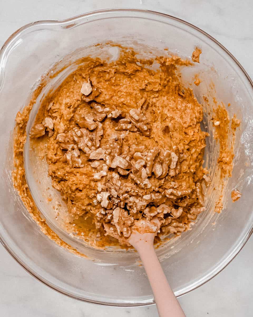 Walnuts added to the dough in a bowl.