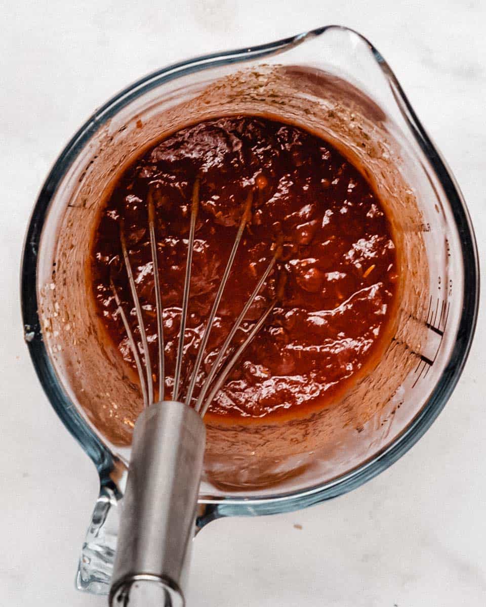 Sauce for the pie whisked together in a mixing jug.