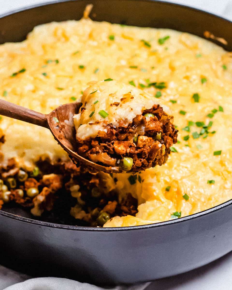 One portion of sheperd's pie on a big spoon.