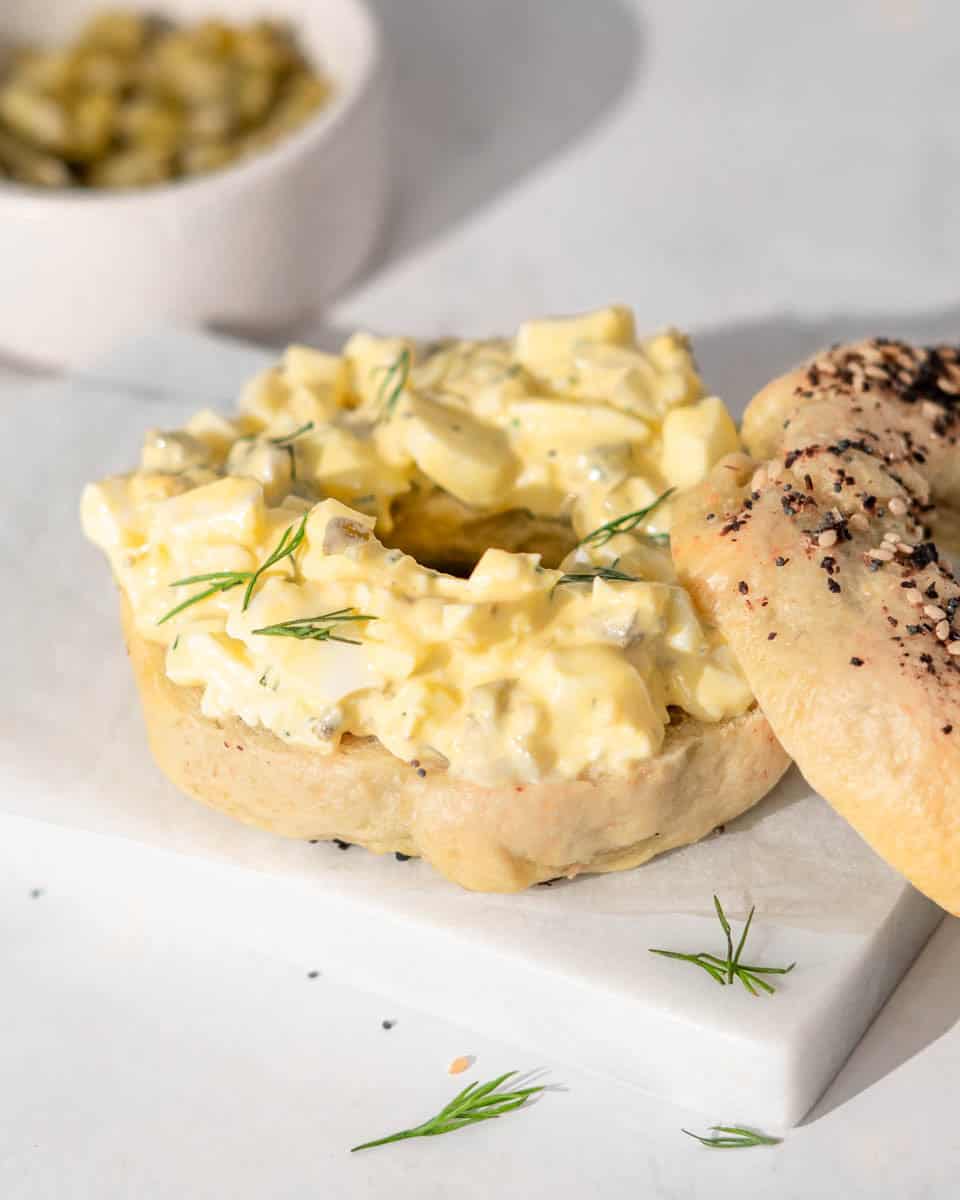 Bagel filled with egg salad. 