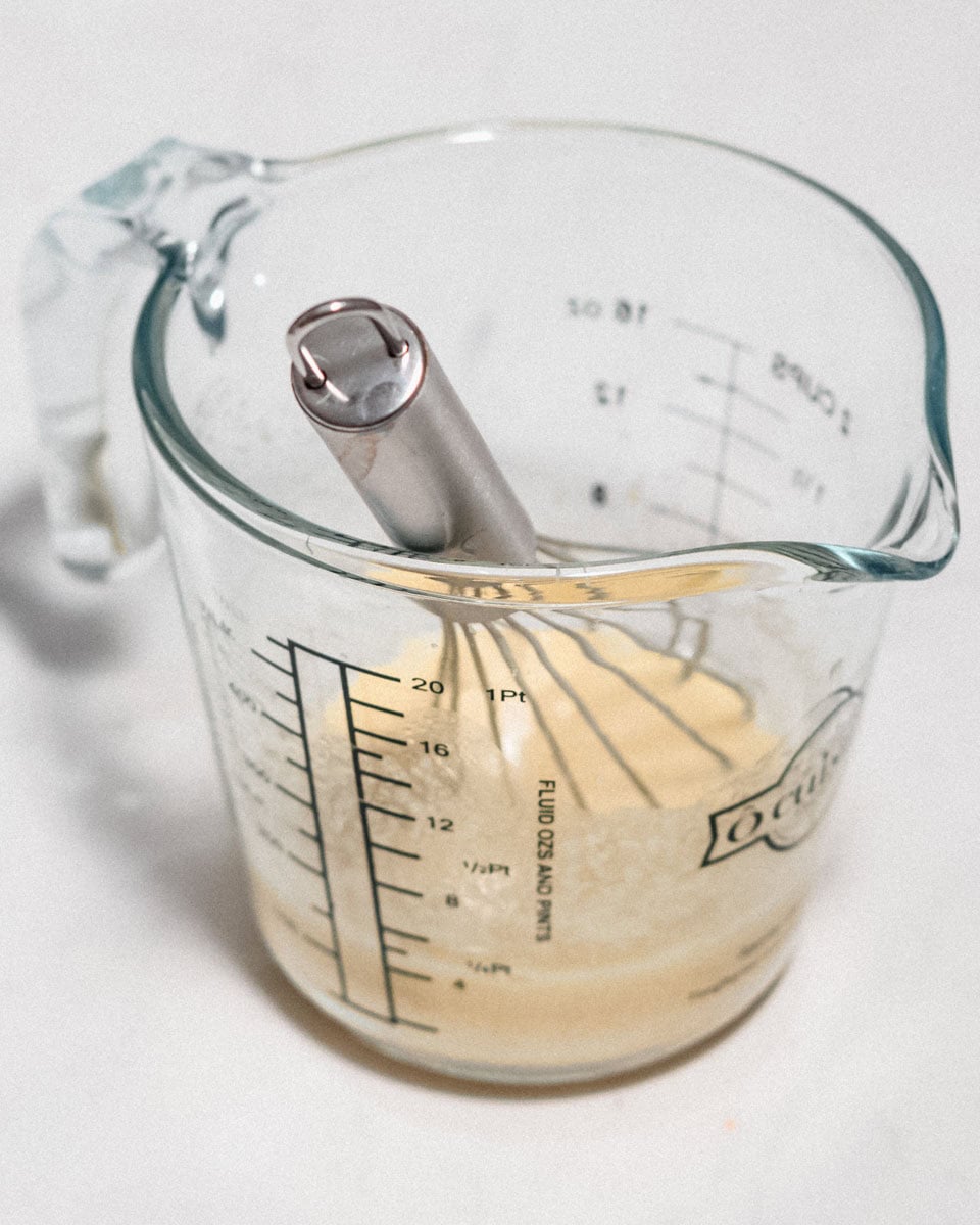 Tahini dressing for the salad in a whisked together in a glas jug.