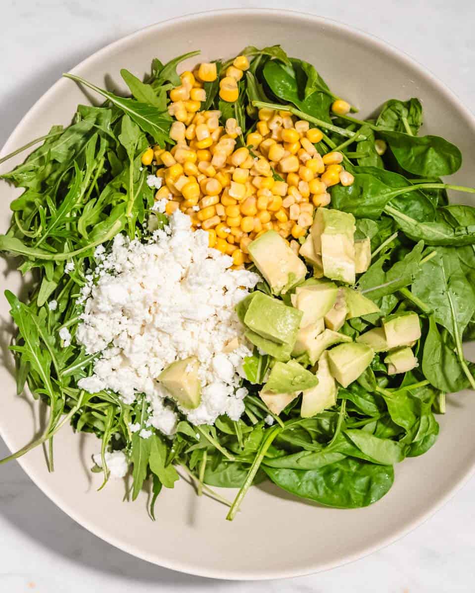 All ingredients for the salad added to a salad bowl. Without the dressing.