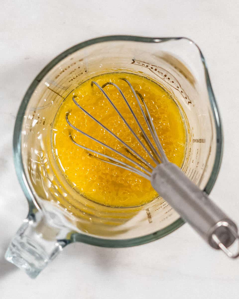 The dressing for this salad whisked together in a glas jug.