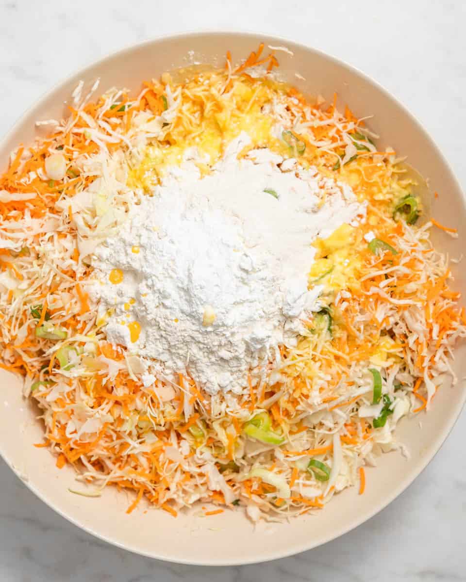 Flour, cornstarch and the egg mixture added on top of the veggies in the bowl.