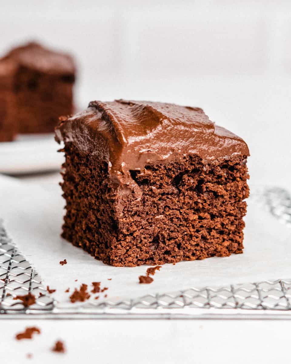 1 piece of chocolate date cake on a wire rack.
