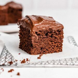 1 piece of chocolate date cake on a wire rack.