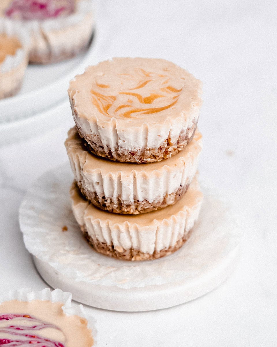 Stack of 3 mini cheesecakes on top of each other.