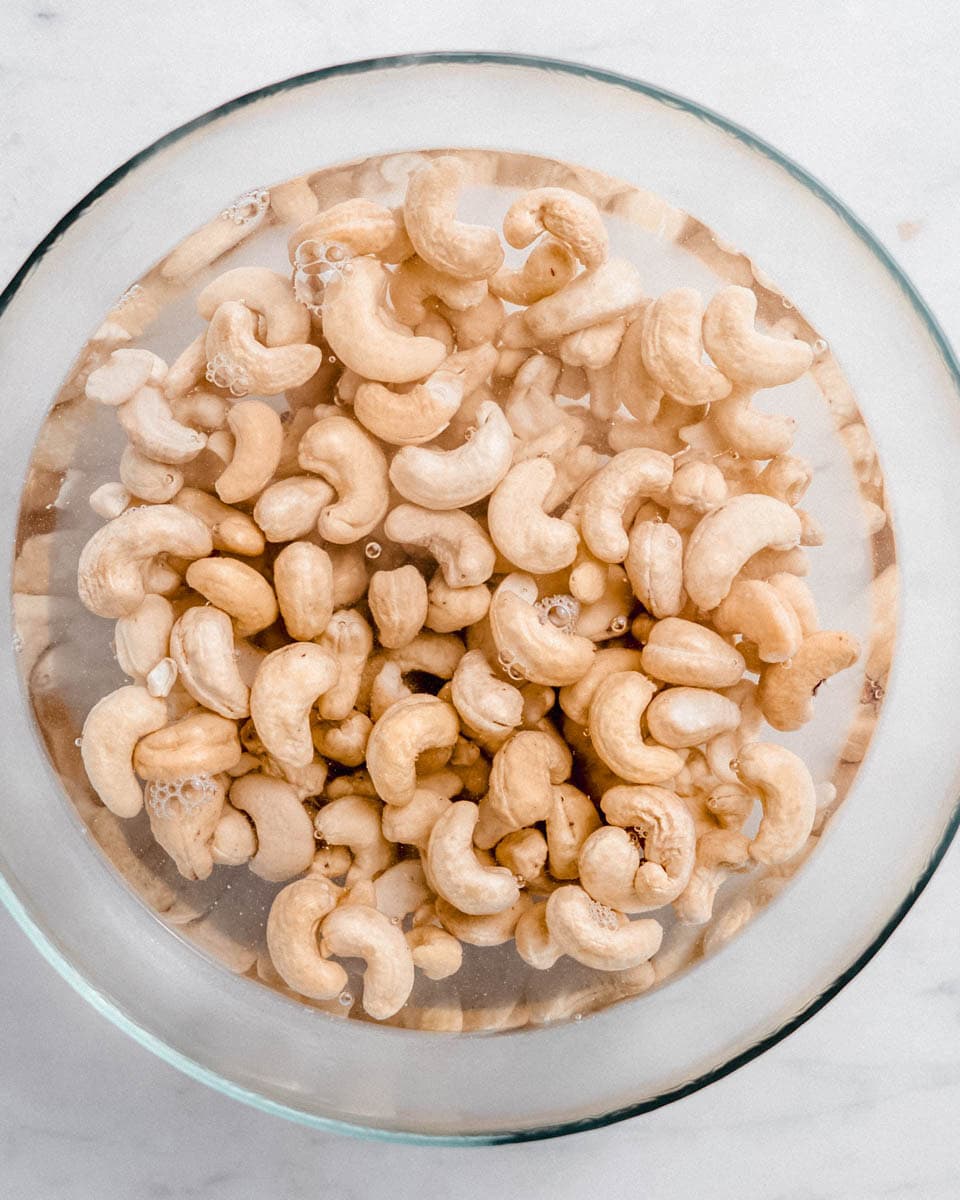 Cashews soaked in a bowl of water.