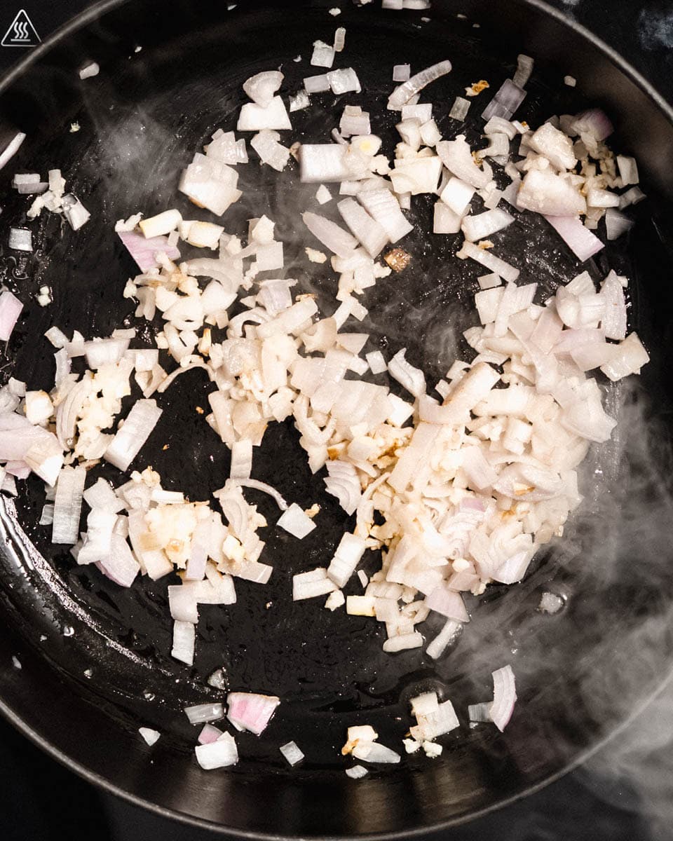 Onion and garlic frying in a pan.